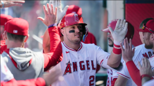 FILE – Los Angeles Angels designated hitter Mike Trout celebrates in the dugout after hitting a home run during the sixth inning of a baseball game against the Baltimore Orioles in Anaheim, Calif., April 24, 2024. (AP Photo/Ashley Landis, File)